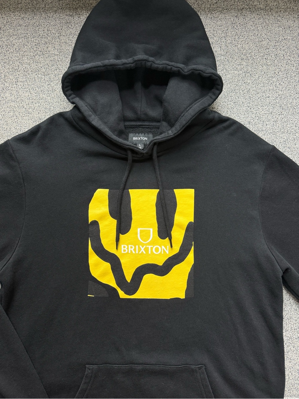 Brixton Men's Black Hoodie with Yellow Smile Graphic
